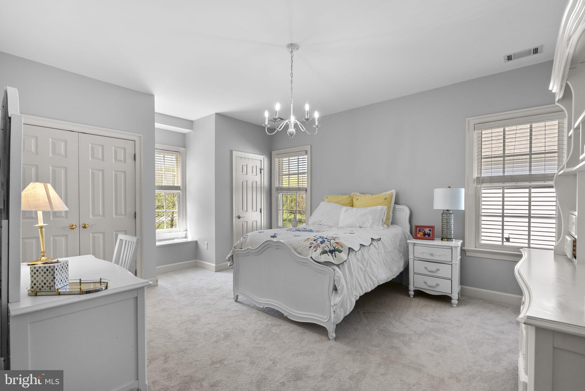 17516 Ashton Green Drive Sandy Spring, MD 20860 - Photo 49 of 60 a bed room with a bed and a chandelier