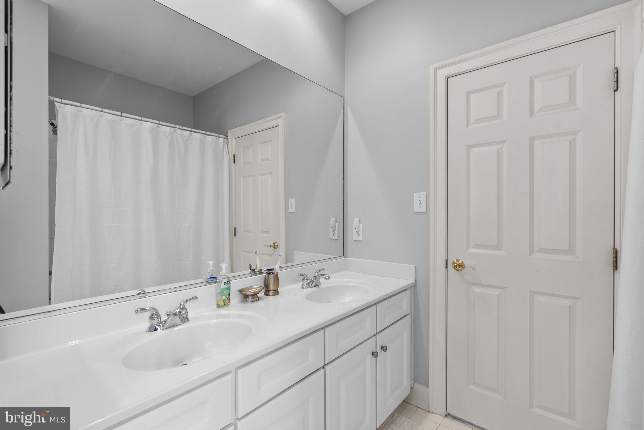 17516 Ashton Green Drive Sandy Spring, MD 20860 - Photo 51 of 60 a bathroom with 2 sink and a mirror