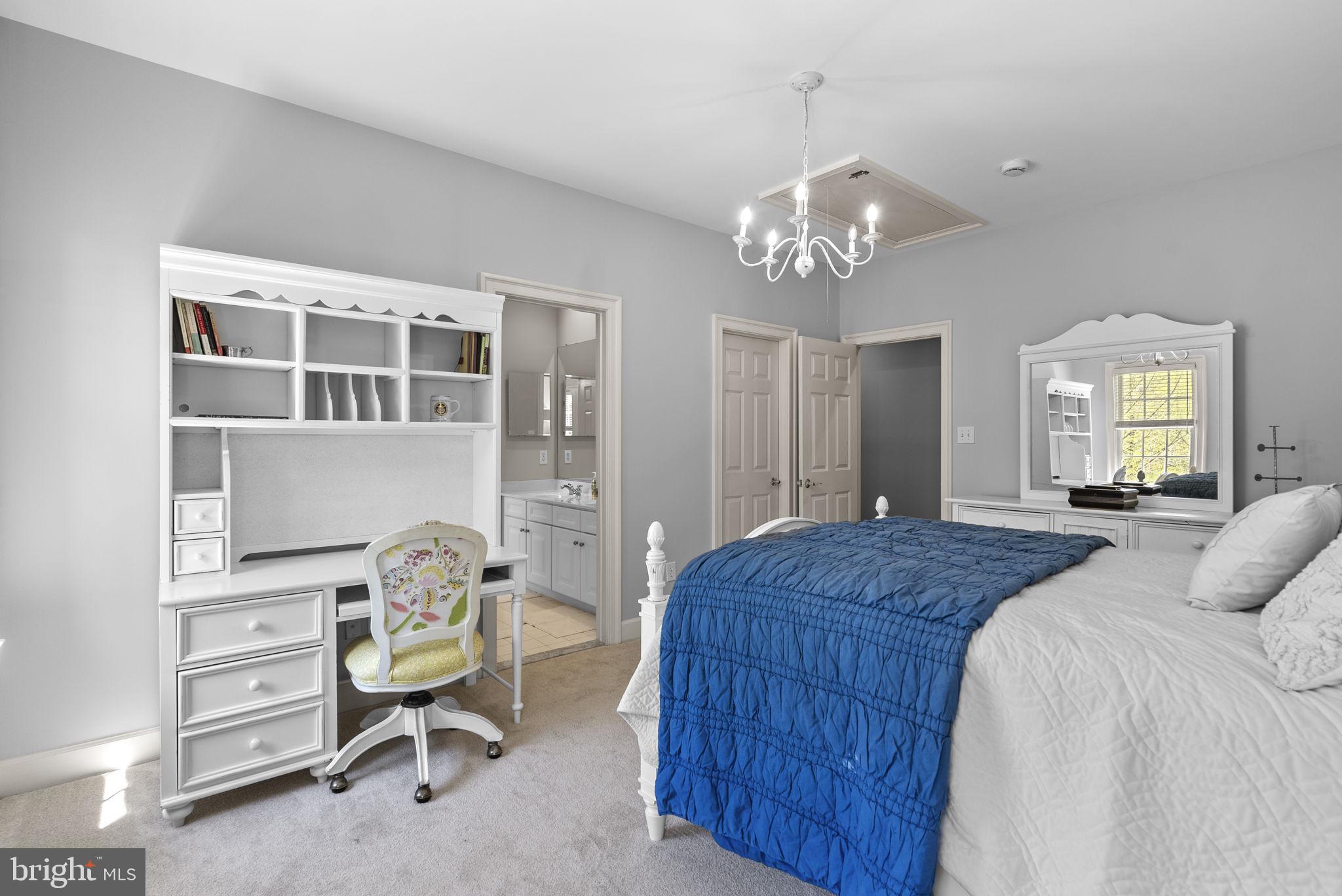 17516 Ashton Green Drive Sandy Spring, MD 20860 - Photo 55 of 60 a bedroom with a bed and a chandelier