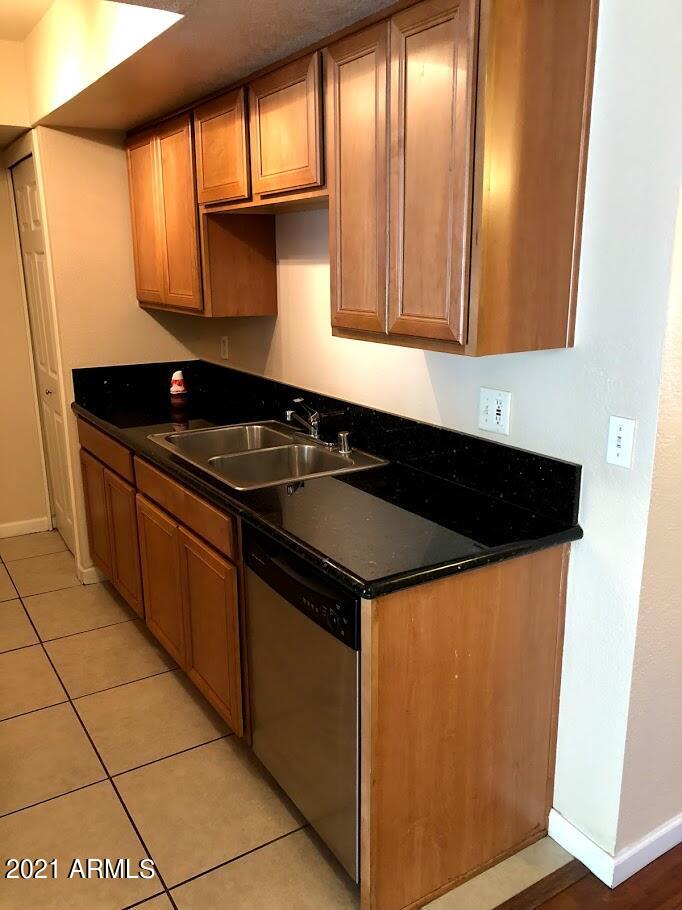740 West Elm Street, Unit 160 Phoenix, AZ 85013 - Photo 14 of 26 a kitchen with granite countertop a sink and a stove