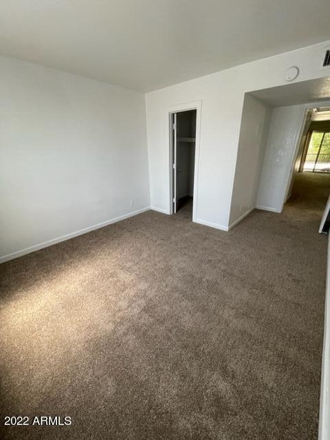 740 West Elm Street, Unit 160 Phoenix, AZ 85013 - Photo 23 of 26 an empty room with closet and windows