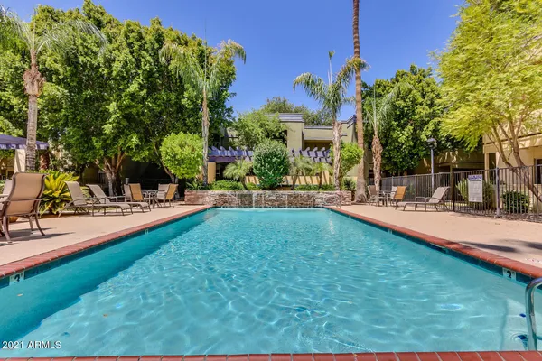 a swimming pool with outdoor seating and yard