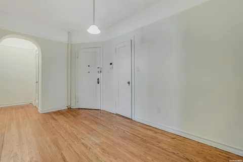 a view of a room with wooden floor