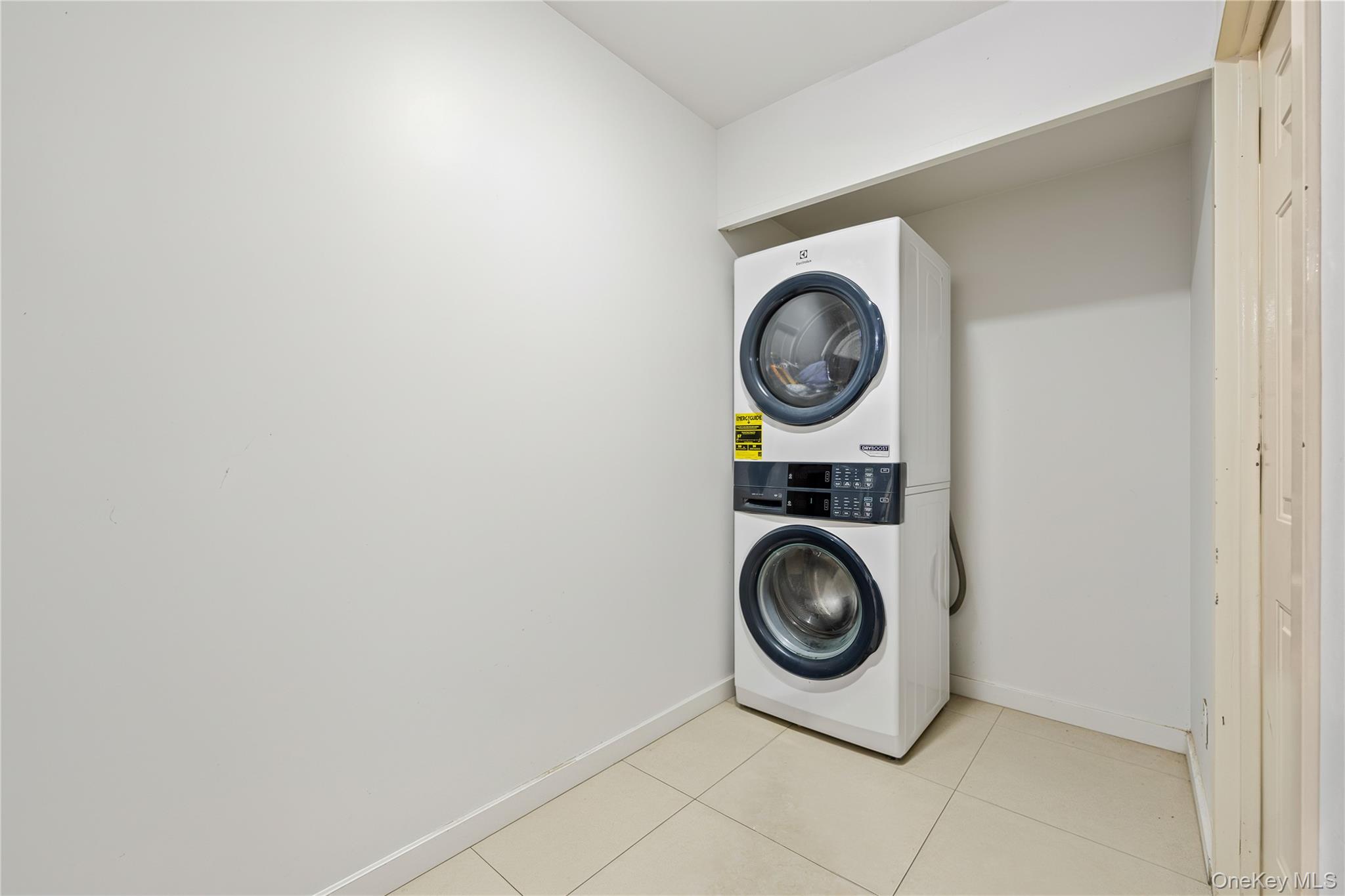 106-07 Northern Boulevard, Unit 5B Queens, NY 11368 - Photo 14 of 18 a utility room with dryer and washer