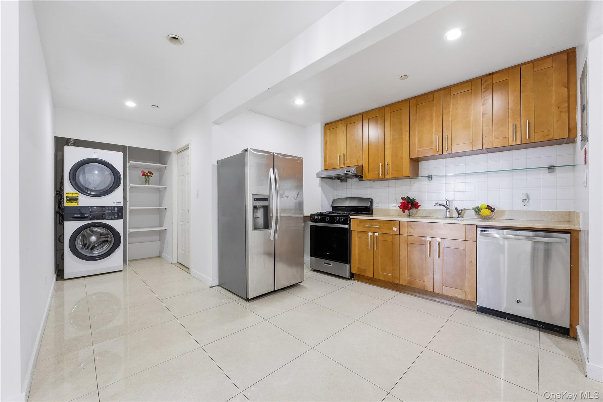 106-07 Northern Boulevard, Unit 5B Queens, NY 11368 - Photo 3 of 19 a kitchen with a refrigerator and cabinets
