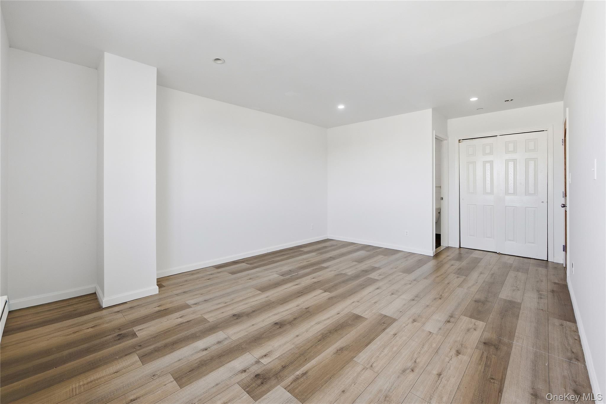 106-07 Northern Boulevard, Unit 5B Queens, NY 11368 - Photo 8 of 19 a view of empty room with wooden floor