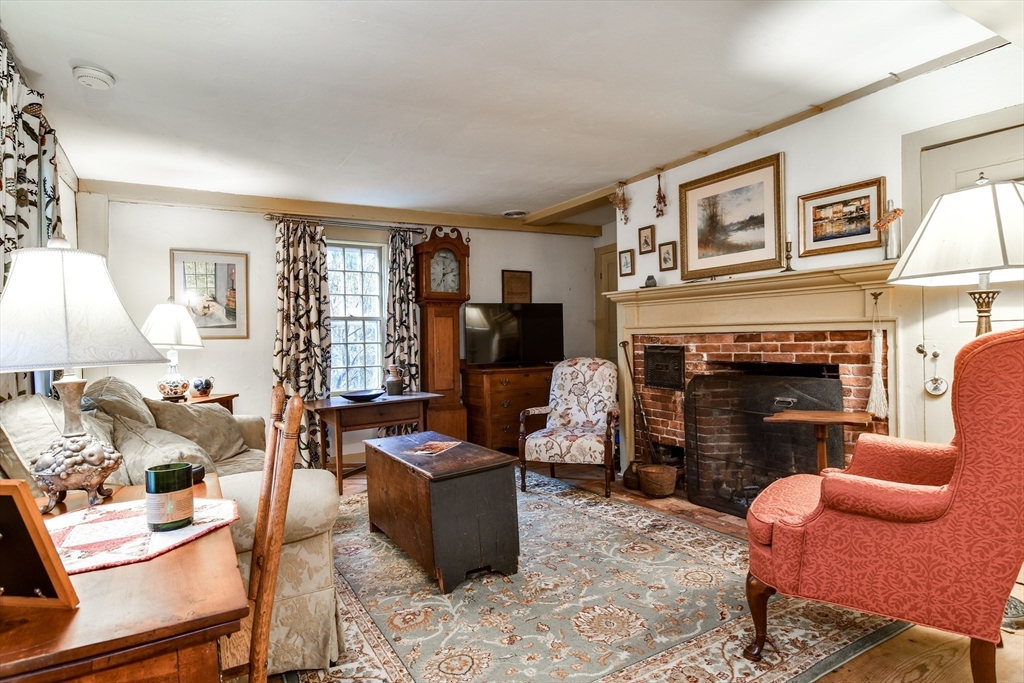 86 Fowler Street Upton, MA 01568 - Photo 13 of 42 a living room with furniture a flat screen tv and a fireplace