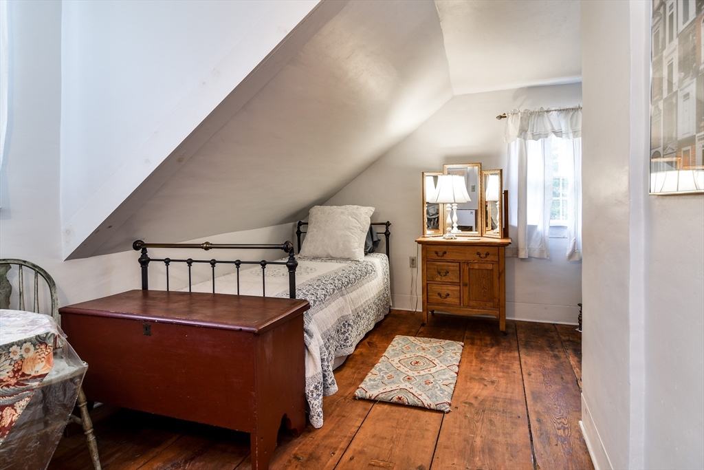 86 Fowler Street Upton, MA 01568 - Photo 21 of 42 a bed room with a bed and a book shelf