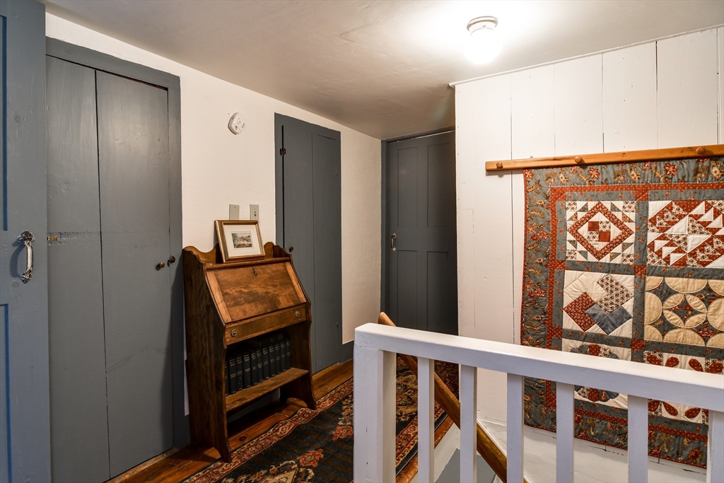 86 Fowler Street Upton, MA 01568 - Photo 23 of 42 a view of a hallway with wooden floor and staircase
