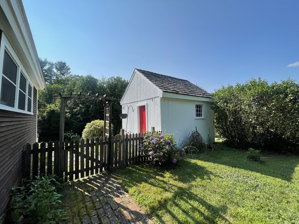 86 Fowler Street Upton, MA 01568 - Photo 29 of 42 a view of a house with brick walls and flower garden