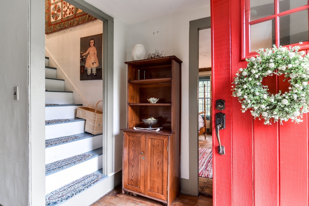 86 Fowler Street Upton, MA 01568 - Photo 3 of 42 a view of a hallway with wooden floor and windows