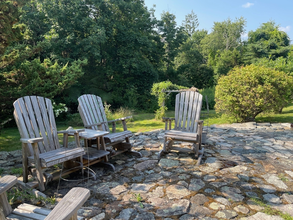 86 Fowler Street Upton, MA 01568 - Photo 31 of 42 a view of a chair and fire pit in backyard