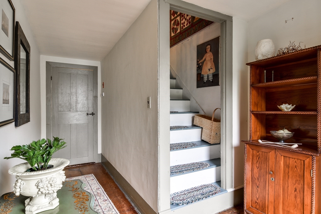 86 Fowler Street Upton, MA 01568 - Photo 4 of 42 a view of a hallway with wooden floor and a bathroom