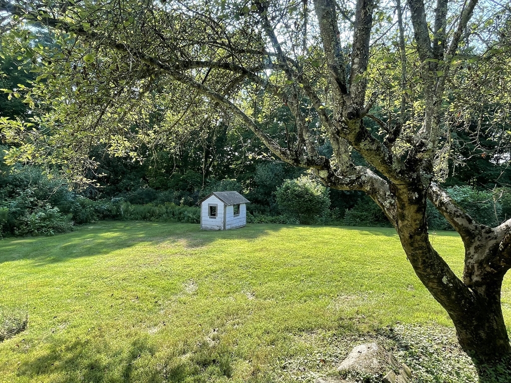 86 Fowler Street Upton, MA 01568 - Photo 42 of 42 a backyard of a house with a yard and a bench