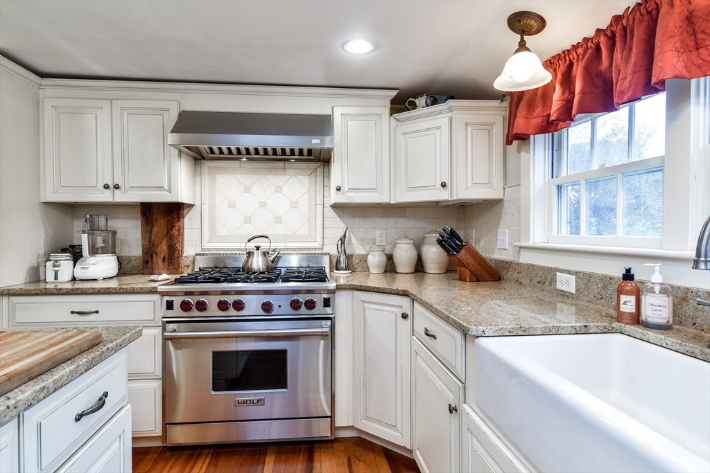 86 Fowler Street Upton, MA 01568 - Photo 8 of 42 a kitchen with stainless steel appliances granite countertop a stove a sink and white cabinets