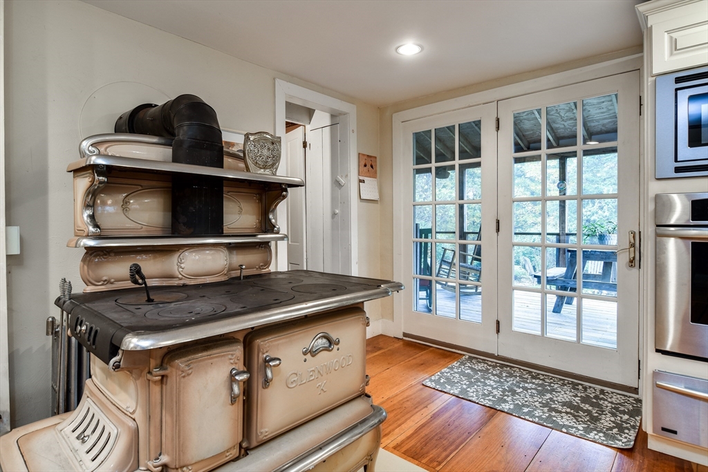 86 Fowler Street Upton, MA 01568 - Photo 10 of 42 a kitchen with a sink and a stove with wooden floor