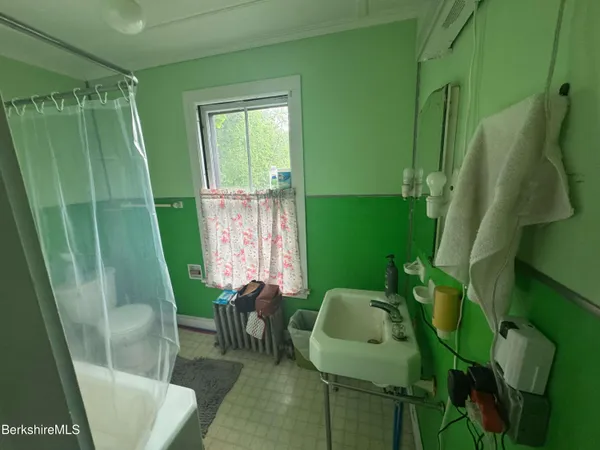 a bathroom with a sink a toilet and a tub