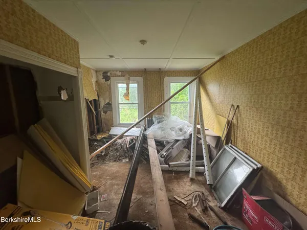 a view of a livingroom with furniture and a window