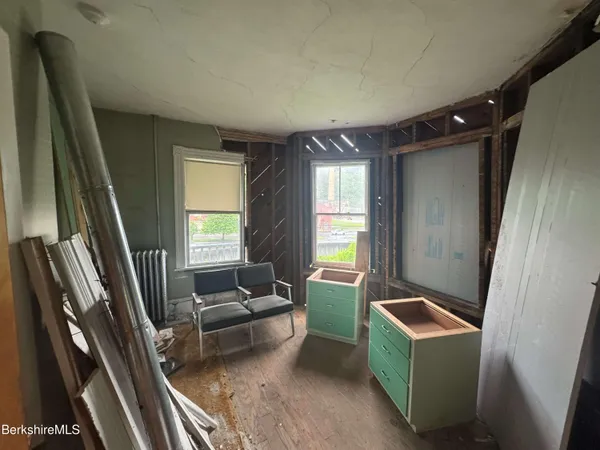 a bedroom with furniture and a window