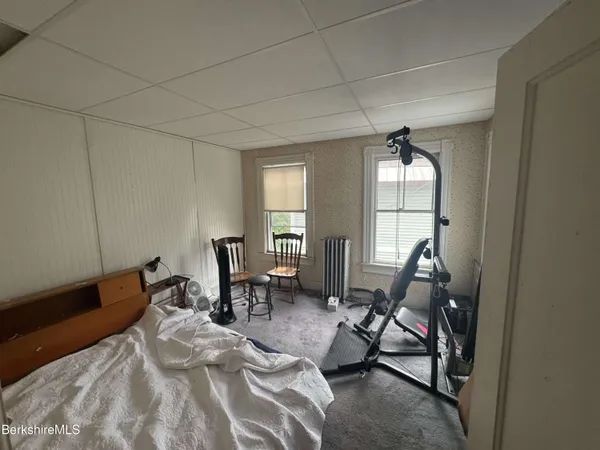 a living room with furniture a flat screen tv and a window