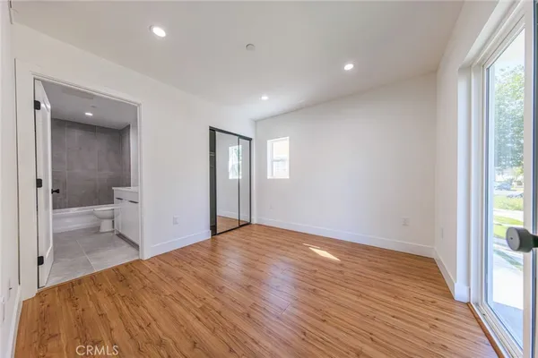 a view of a room with a hardwood and a bathroom