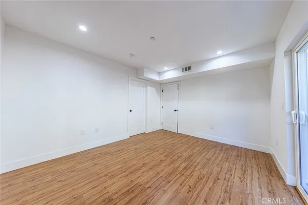 a view of room with wooden floor