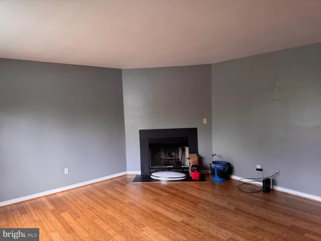 a view of a livingroom with a fireplace and a wooden floor