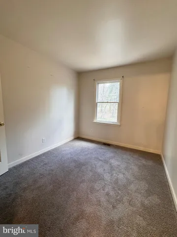 a bathroom with a granite countertop sink toilet a mirror and shower