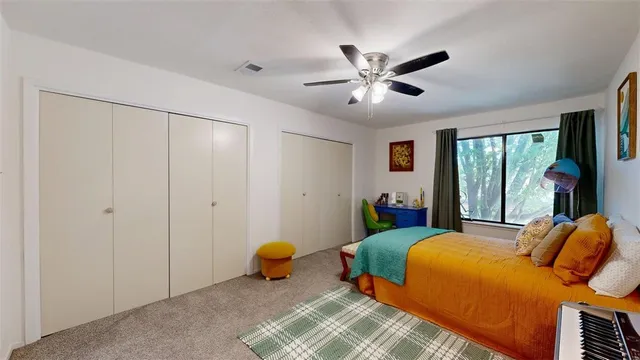 a bedroom with furniture and a lamp