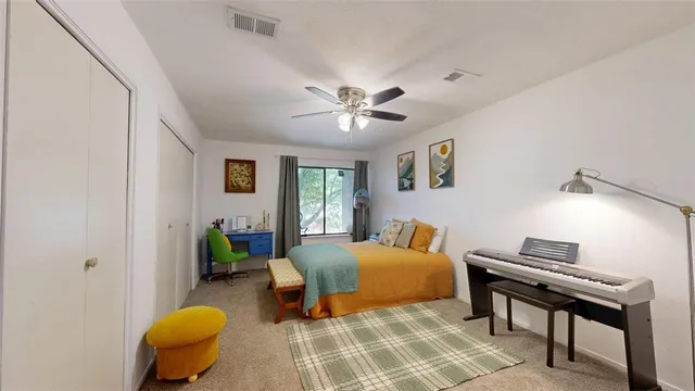 a bedroom with a bed and a chair