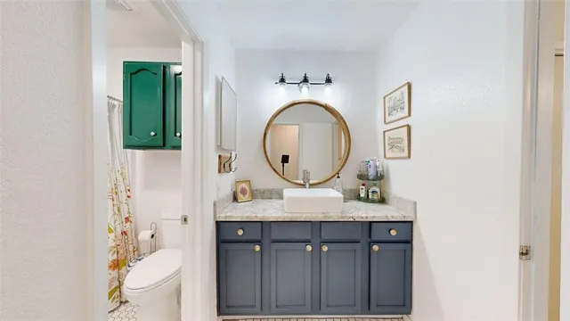 a bathroom with a granite countertop sink a mirror and a shower