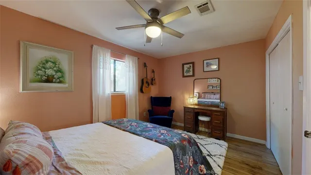 a bedroom with a bed dresser and a window