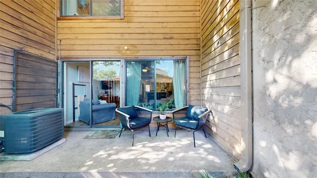 a view of a patio with table and chairs and potted plants