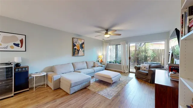 a living room with furniture and kitchen view