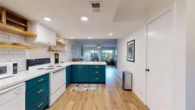 a open kitchen with cabinets table and chairs