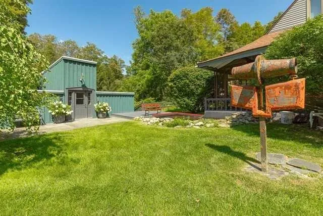 a view of a house with a backyard