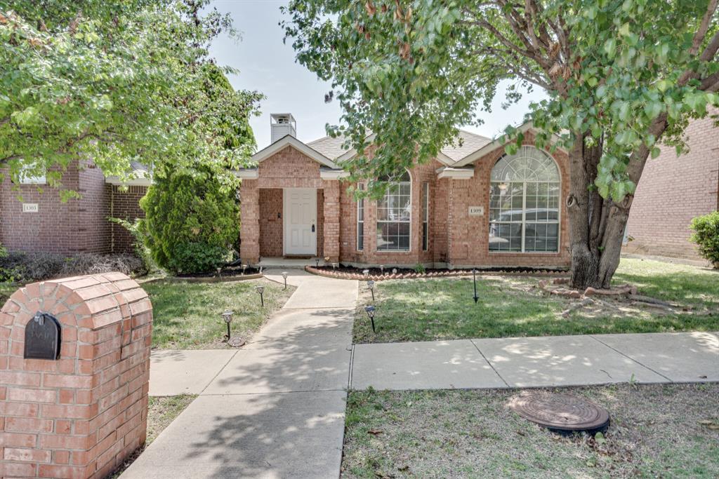 1309 Riley Drive Carrollton, TX 75007 - Photo 1 of 1 a front view of a house with garden