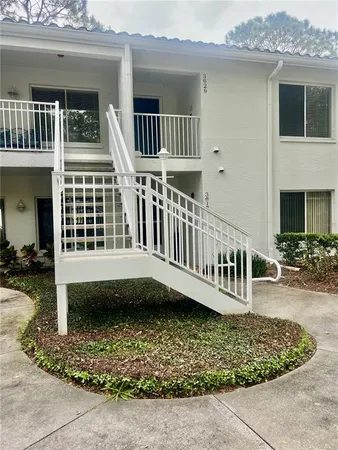 a view of a house with backyard and porch