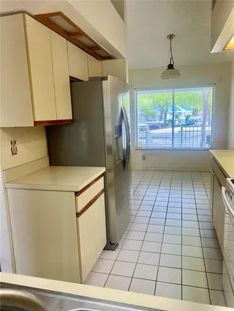 a kitchen with a white cabinets and white appliances