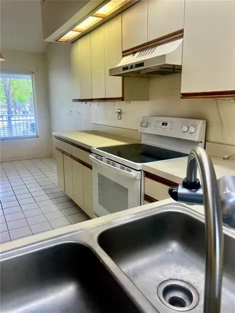 a kitchen with a sink and a stove