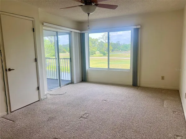 en empty room with windows and outdoor view