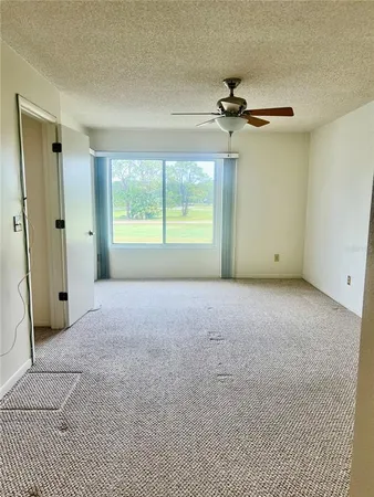 an empty room with a bathroom and a mirror