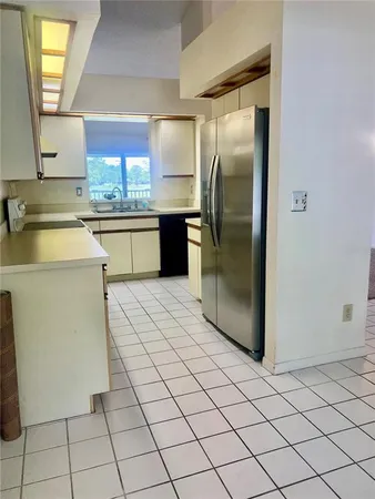 a kitchen with stainless steel appliances a refrigerator sink and cabinets