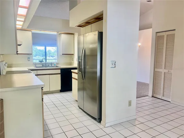 a kitchen with stainless steel appliances a refrigerator and a sink
