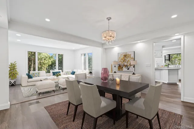 a view of a dining room with furniture wooden floor and chandelier