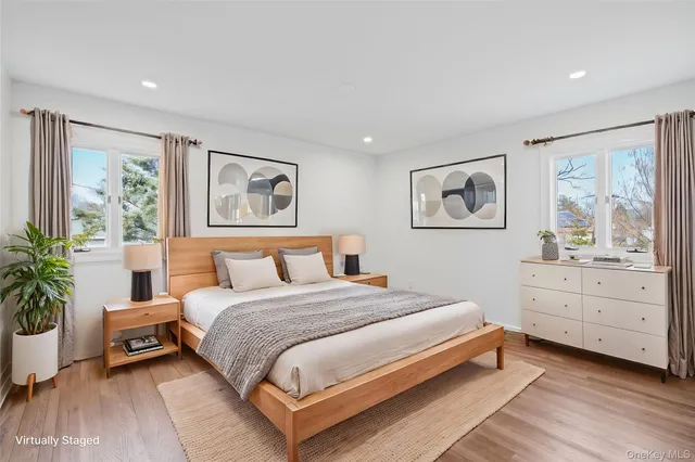 a bedroom with a large bed and paintings on the wall