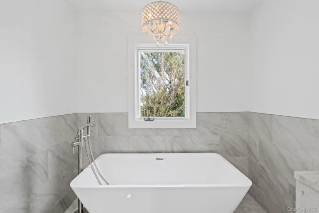 a bathroom with a bathtub and window