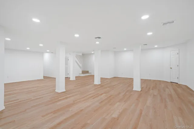 a view of an empty room with wooden floor