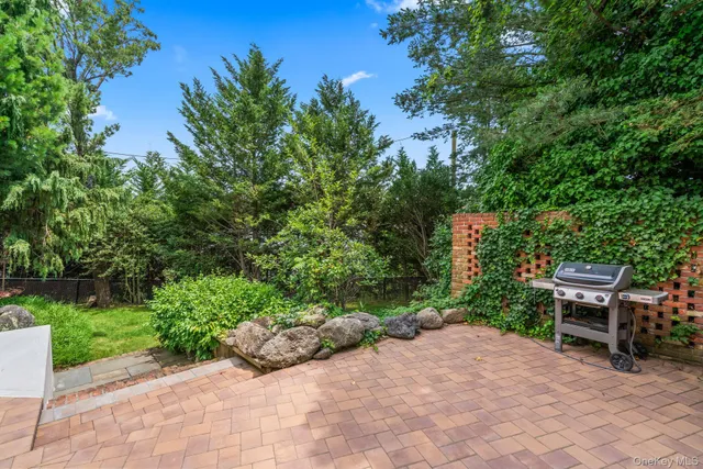 a view of a chair and table in the garden