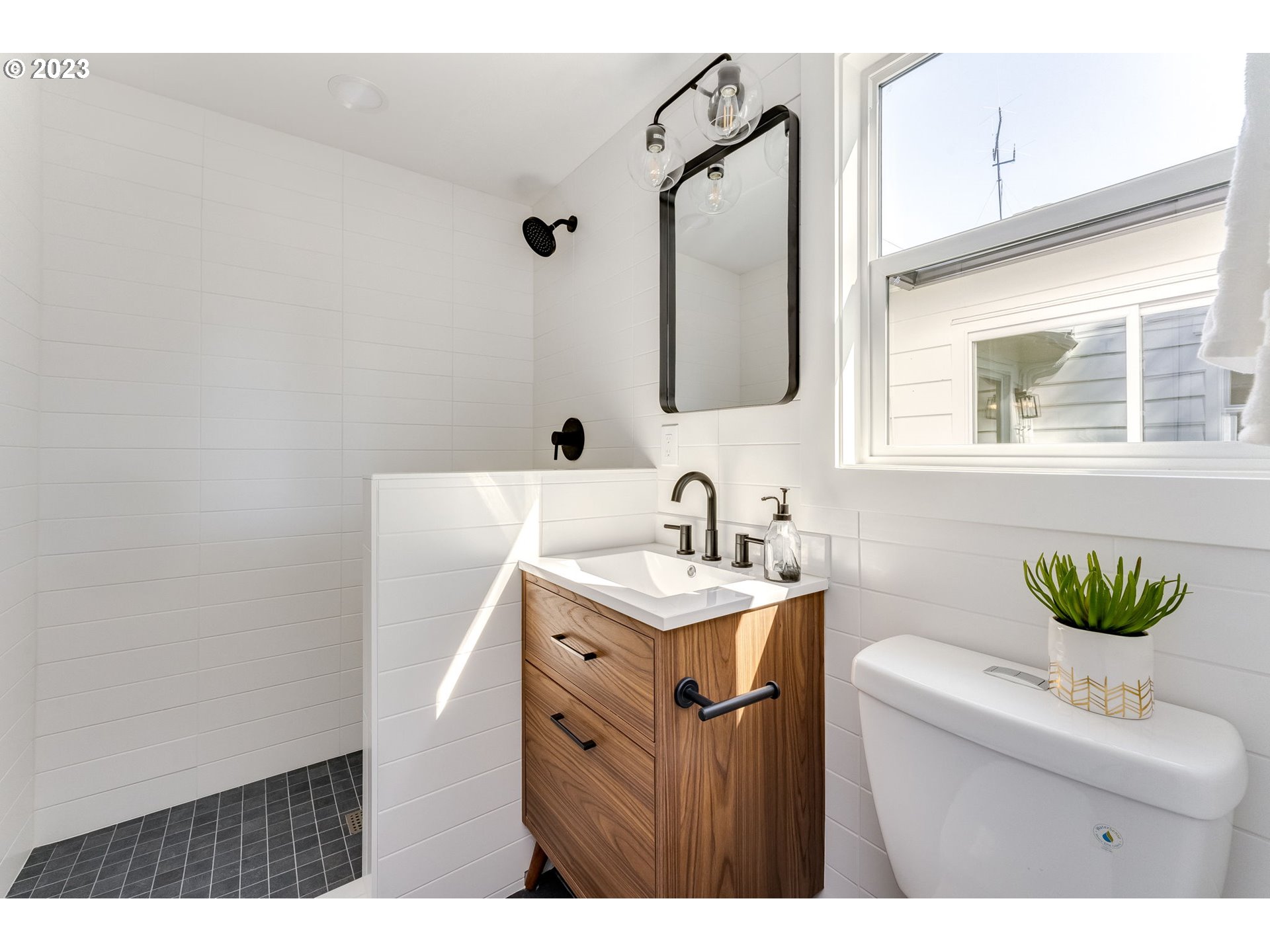 3842 North Alaska Street Portland, OR 97217 - Photo 30 of 36 a bathroom with a sink and a mirror